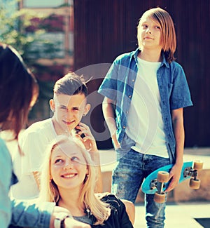 Teenagers communicate in schoolyard