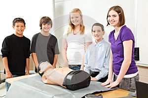 Teenagers with CPR Training Mannequin photo