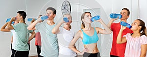 Teenagers drinking water in choreography class