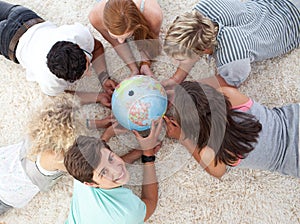 Teenagers examining a terrestrial globe photo