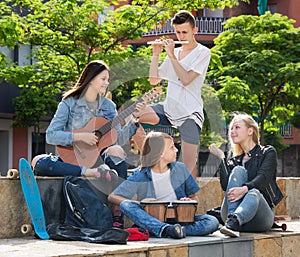 Teenagers friends playing musical instruments