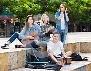 Teenagers friends playing musical instruments