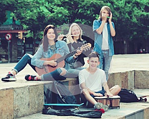 Teenagers friends playing musical instruments