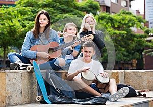 Teenagers friends playing musical instruments