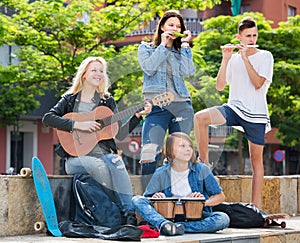 Teenagers friends playing musical instruments