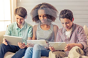 Teenagers with gadgets at home