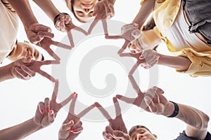 Teenagers hands making a star. Male and female palms in circle. Five funny laughing teens building sun shape with their fingers