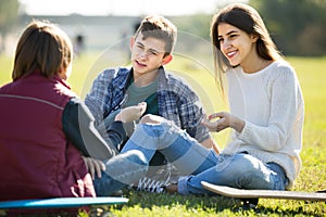 Teenagers hanging out outdoors and discussing something