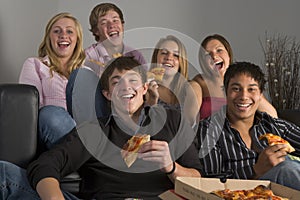 Teenagers Having Fun And Eating Pizza