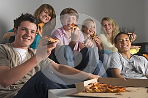 Teenagers Having Fun And Eating Pizza