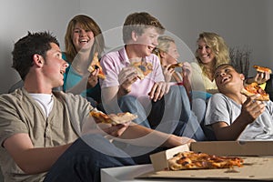 Teenagers Having Fun And Eating Pizza