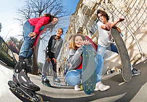 Teenagers with inline skates and skateboards