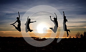 Teenagers jumping in sunset for fun