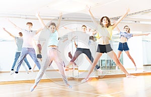 Teenagers jumping together during dance workout