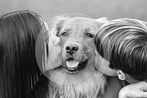 Teenagers Kissing Dog