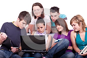 Teenagers looking at laptop