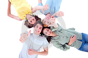 Teenagers lying down with thumbs up