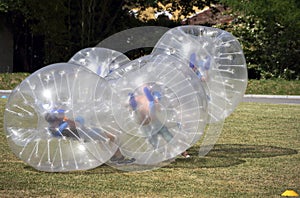 Teenagers play in Bubble bump game outdoor