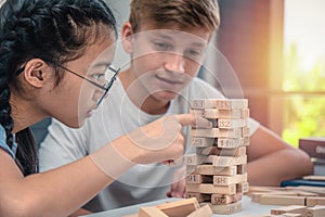 Teenagers play Jenga game together photo