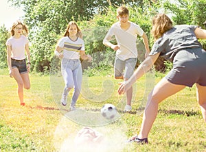 Teenagers play street football with excitement in park