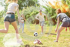 Teenagers play street football with excitement in park