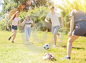 Teenagers play street football with excitement in park