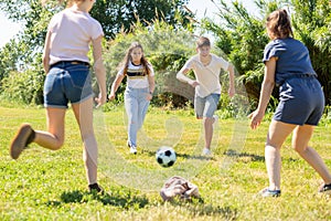 Teenagers play street football with excitement in park