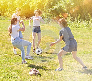 Teenagers play street football with excitement in park