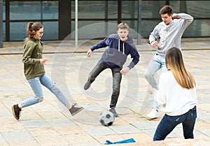 Teenagers play street football with excitement on street
