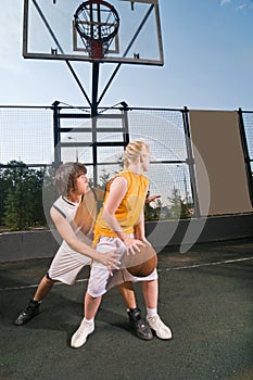 Teenagers playing basketball