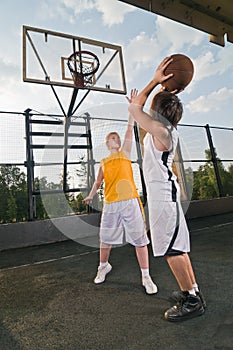 Teenagers playing basketball