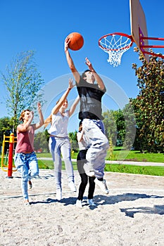 Teenagers playing basketball