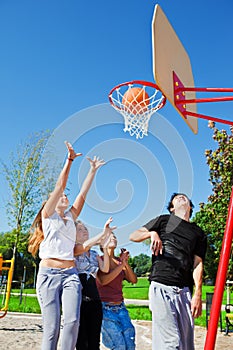 Teenagers playing basketball