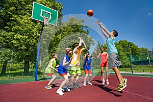 Teenagers playing basketball game together