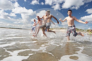 Teenagers playing on beach