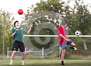 Teenagers playing football on field