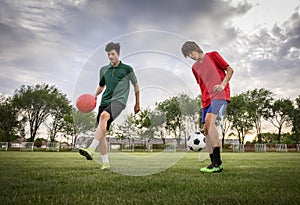 Teenagers playing football on field