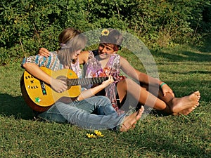 Teenagers playing guitar