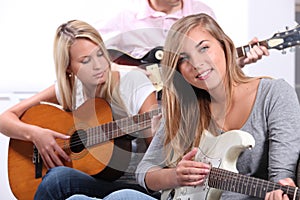 Teenagers playing the guitar