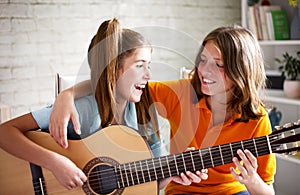 Teenagers playing guitar