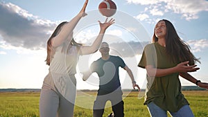 teenagers playing rugby in the park. a group of teenagers play american football run outdoors in the park in summer