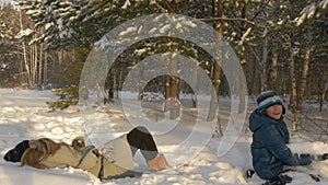 Teenagers playing in the snow.