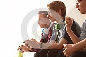 Teenagers playing video games at home