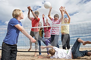 Teenagers playing volleyball