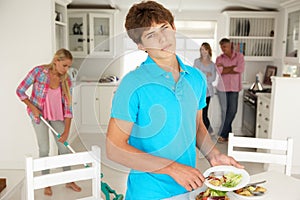 Teenagers reluctantly doing housework