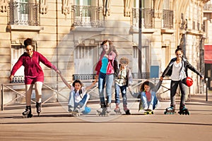 Teenagers rollerblading and skateboarding together