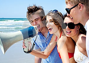 Teenagers shouting through megaphone