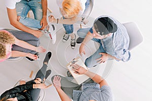 Teenagers sitting in circle