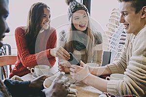 Teenagers Socialising In A Winter Cafe