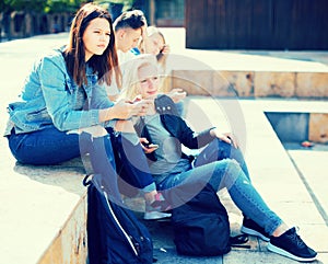Teenagers socialize near the school